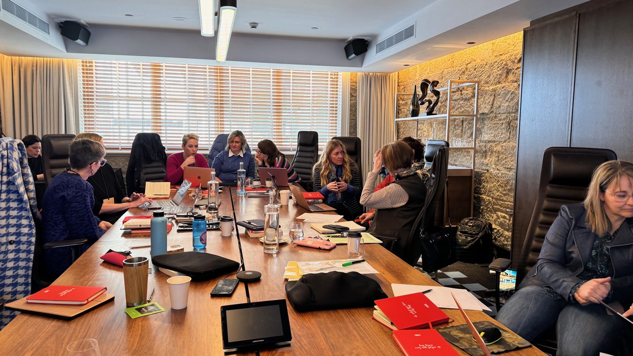 Boardroom members working around the table at a quarterly session